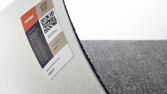 Het Niaga-label op het tapijt schrijft voor dat het product niet mag worden weggegooid en geeft ook aanvullende informatie, zoals de materiaalsamenstelling en retourprocedure. Het Niaga label